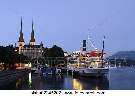 Stock Image - "Floating restaurant in front of the Hofkirche St. Leodegar church, Lucerne, Switzerland, Europe". Fotosearch