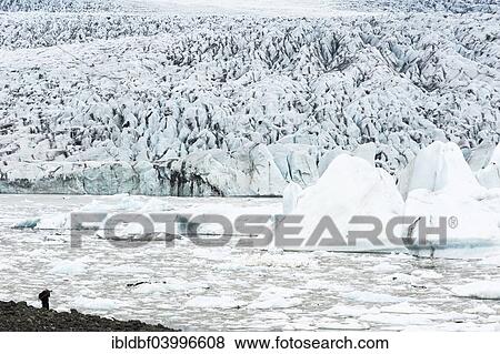 "Floe, icebergs, glacier, glacier lagoon, man taking pictures of Breioarlon and Vatnajokull glacier, Austurland, Iceland, Europe" View Large Photo Image Stock Photo - "Floe, icebergs, glacier, glacier lagoon, man taking pictures of Breioarlon and Vatnajokull glacier, Austurland, Iceland, Europe". Fotosearch