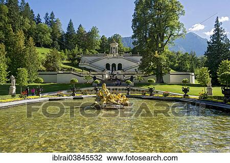 "Flora Fountain surrounded by a water basin, the Venus Temple and terraced gardens at the back, Konigslinde linden tree, castle grounds, Linderhof Palace, Upper Bavaria, Bavaria, Germany, Europe" View Large Photo Image Stock Image - "Flora Fountain surrounded by a water basin, the Venus Temple and terraced gardens at the back, Konigslinde linden tree, castle grounds, Linderhof Palace, Upper Bavaria, Bavaria, Germany, Europe". Fotosearch