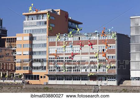 "Flossis figures on Roggendorf House, Media Harbour, Dusseldorf, North Rhine-Westphalia, Germany, Europe" View Large Photo Image Stock Photo - "Flossis figures on Roggendorf House, Media Harbour, Dusseldorf, North Rhine-Westphalia, Germany, Europe". Fotosearch