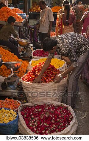 Stock Photograph - "Flower seller at a market stall, Mysore, Karnataka, India, Asia". Fotosearch
