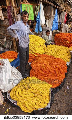Stock Image - "Flower seller, Malik Ghat Flower Market, Kolkata, West Bengal, India, Asia". Fotosearch