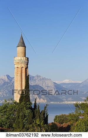 Stock Image - "Fluted Minaret, behind the Taurus Mountains, Kaleici, Antalya, Antalya Province, Turkey, Asia". Fotosearch