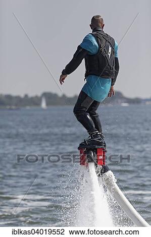 "Flyboarder on the water jet of a jet ski, Walcheren, Zeeland province, The Netherlands, Europe" View Large Photo Image Stock Image - "Flyboarder on the water jet of a jet ski, Walcheren, Zeeland province, The Netherlands, Europe". Fotosearch