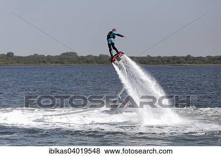 Stock Photo - "Flyboarder on the water jet of a jet ski, Walcheren, Zeeland province, The Netherlands, Europe". Fotosearch