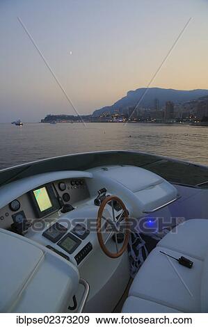 Stock Photo - "Flybridge, Leonardo II, a cruiser built by Azimut, type of boat: Leonardo 98, length: 30. 15 m, built in 2004, off Monaco at dusk, French Riviera, France, Mediterranean Sea, Europe". Fotosearch