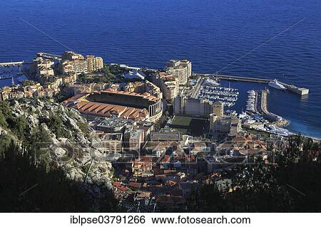 "Fontvieille, district built on reclaimed land, with the football stadium and the Port of Cap d'Ail, seen from underneath the Tete du Chien, Principality of Monaco, Mediterranean" View Large Photo Image Stock Photograph - "Fontvieille, district built on reclaimed land, with the football stadium and the Port of Cap d'Ail, seen from underneath the Tete du Chien, Principality of Monaco, Mediterranean". Fotosearch
