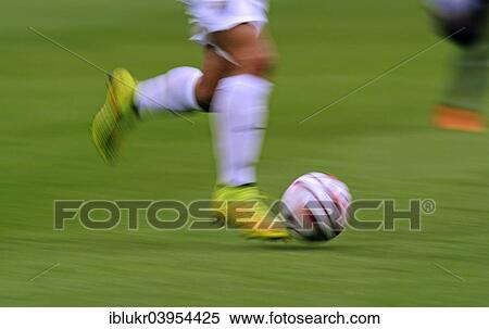 "Football player, blurred player's legs playing a football, Malaga CF vs Newcastle United, 3: 1, Veltins Arena, Gelsenkirchen, Germany, Europe" View Large Photo Image Stock Photography - "Football player, blurred player's legs playing a football, Malaga CF vs Newcastle United, 3: 1, Veltins Arena, Gelsenkirchen, Germany, Europe". Fotosearch