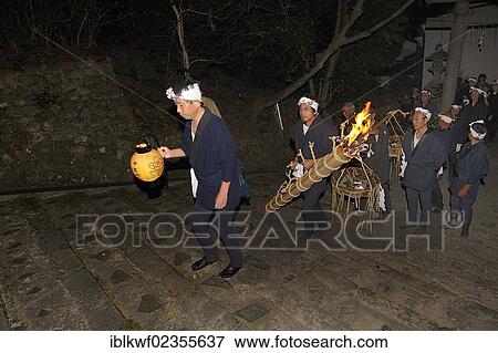 Stock Photo - "For a fire-Matsuri in Autumn torches are lit in each district and carried through the streets to the Shinto shrine, Iwakura in Kyoto, Japan, Asia". Fotosearch