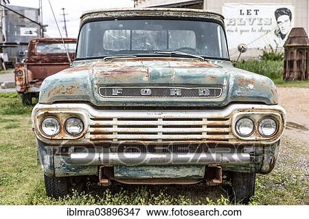 "Ford F100, American classic car with a rusty radiator grill, corrugated iron huts and an Elvis poster at the back, Clarksdale, Mississippi, United States, North America" View Large Photo Image Stock Photo - "Ford F100, American classic car with a rusty radiator grill, corrugated iron huts and an Elvis poster at the back, Clarksdale, Mississippi, United States, North America". Fotosearch