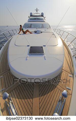 "Foredeck, Leonardo II, a cruiser built by Azimut, type of boat: Leonardo 98, length: 30. 15 m, built in 2004, a young woman wearing a bikini sitting on the foredeck, French Riviera, France, Mediterranean Sea, Europe" View Large Photo Image Stock Image - "Foredeck, Leonardo II, a cruiser built by Azimut, type of boat: Leonardo 98, length: 30. 15 m, built in 2004, a young woman wearing a bikini sitting on the foredeck, French Riviera, France, Mediterranean Sea, Europe". Fotosearch