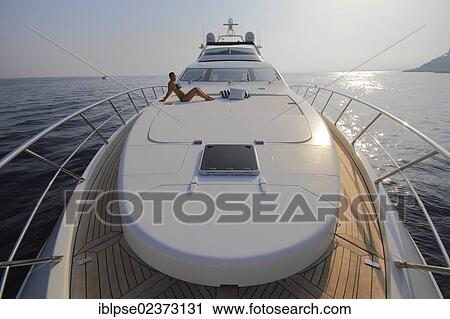 "Foredeck, Leonardo II, a cruiser built by Azimut, type of boat: Leonardo 98, length: 30. 15 m, built in 2004, a young woman wearing a bikini sitting on the foredeck, French Riviera, France, Mediterranean Sea, Europe" View Large Photo Image Stock Image - "Foredeck, Leonardo II, a cruiser built by Azimut, type of boat: Leonardo 98, length: 30. 15 m, built in 2004, a young woman wearing a bikini sitting on the foredeck, French Riviera, France, Mediterranean Sea, Europe". Fotosearch