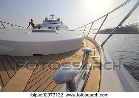 "Foredeck, Leonardo II, a cruiser built by Azimut, type of boat: Leonardo 98, length: 30. 15 m, built in 2004, a young woman wearing a bikini sitting on the foredeck, French Riviera, France, Mediterranean Sea, Europe" View Large Photo Image Stock Image - "Foredeck, Leonardo II, a cruiser built by Azimut, type of boat: Leonardo 98, length: 30. 15 m, built in 2004, a young woman wearing a bikini sitting on the foredeck, French Riviera, France, Mediterranean Sea, Europe". Fotosearch