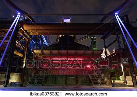 Stock Image - "Former casting house, illuminated, disused steelworks, Landscape Park Duisburg-Nord, Ruhr area, North Rhine-Westphalia, Germany, Europe". Fotosearch