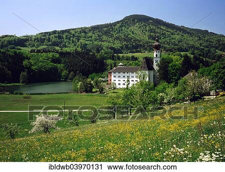 Stock Image - "Former Hoglworth Abbey on a peninsula in Lake Hoglworth, Anger, Rupertigau, Upper Bavaria, Bavaria, Germany, Europe". Fotosearch