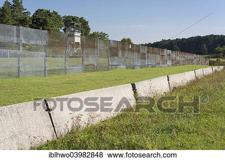 Stock Photo - "Former inner German border, death zone, border fence and car ditch, American observation tower at the back, now memorials and museums, Point Alpha Memorial, Geisa, Rhon Mountains, Thuringia, Germany, Europe". Fotosearch