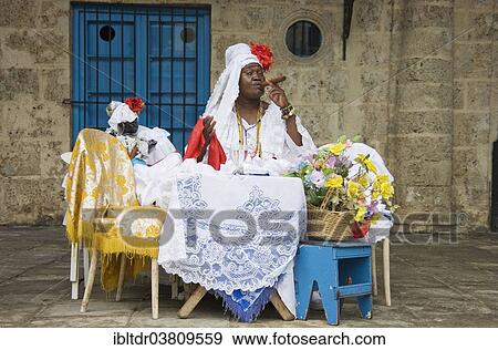 Stock Photo - "Fortune teller posing with a cigar, Havana, Cuba, North America". Fotosearch