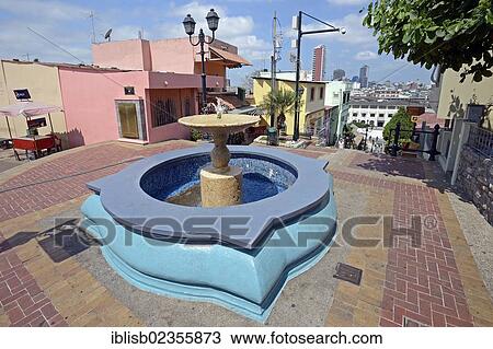 Stock Image - "Fountain and colourful houses in the Las Penas neighbourhood on Cerro Santa Ana, Guayaquil, Ecuador, South America". Fotosearch