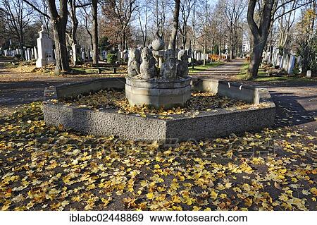 Stock Photo - "Fountain with autumn leaves, Ostfriedhof, East Cemetery, Munich, Bavaria, Germany, Europe". Fotosearch