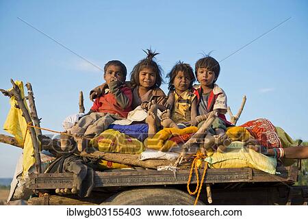 Stock Image - "Four children sitting on a camel cart, Pushkar Camel Fair, Pushkar, Rajasthan, India, Asia". Fotosearch
