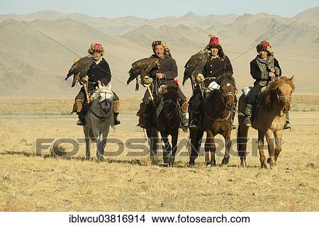 Picture - "Four Kazakh eagle hunters on their horses on the way to the Eagle Festival in Sagsai, Bayan-Oelgii Aimag, Mongolia, Asia". Fotosearch