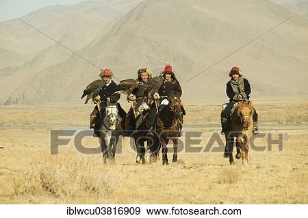 "Four Kazakh eagle hunters on their horses on the way to the Eagle Festival in Sagsai, Bayan-Oelgii Aimag, Mongolia, Asia" View Large Photo Image Stock Photo - "Four Kazakh eagle hunters on their horses on the way to the Eagle Festival in Sagsai, Bayan-Oelgii Aimag, Mongolia, Asia". Fotosearch