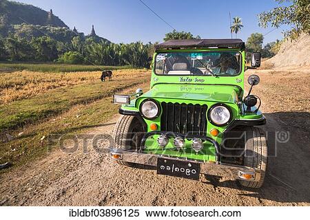 Stock Photography - "Four-wheel drive vehicle, Jeep on a dirt road, Mrauk U, Sittwe District, Rakhine State, Myanmar, Asia". Fotosearch
