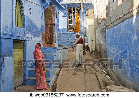 Stock Photo - "Four women in traditional saris in an alleyway with blue houses, Brahmpuri, Jodhpur, Rajasthan, India, Asia". Fotosearch