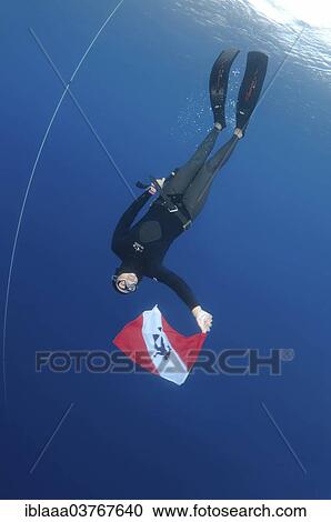 "Freediver holds a diver down flag, Aegean Sea, Symi, Greece, Europe" View Large Photo Image Stock Image - "Freediver holds a diver down flag, Aegean Sea, Symi, Greece, Europe". Fotosearch