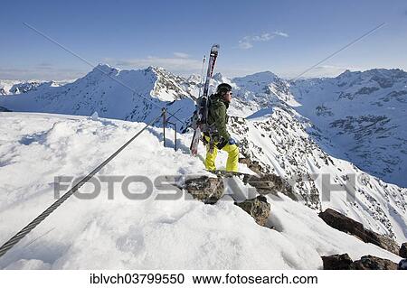 Stock Image - "Freeride skier standing on the ridge, Winterklettersteig climbing route, Arlberg, Verwall Group, North Tyrol, Austria, Europe". Fotosearch