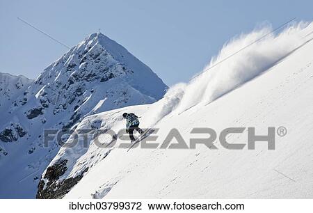 Stock Image - "Freerider, snowboarder descending, in front of Standkopf Mountain, Sagtaler Spitze Mountain, Alpbach Valley, Kitzbuhel Alps, North Tyrol, Austria, Europe". Fotosearch