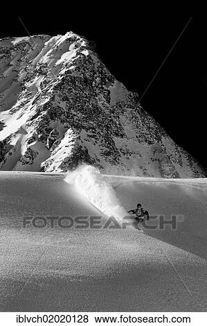 Stock Photo - "Freerider snowboarding in deep snow, Stubai Glacier, North Tyrol, Austria, Europe". Fotosearch