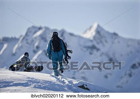 Stock Image - "Freeriders, snowboarders walking to the slope, snowy landscape, Alpbach, northern Tyrol, Austria, Europe". Fotosearch