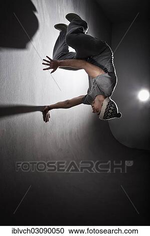Stock Image - "Freerunner jumping and turning off a wall, Innsbruck, Tyrol, Austria, Europe". Fotosearch