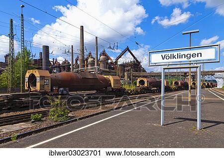 "Freight transport by train, in front of the Voelklingen Ironworks, Voelklingen station, city centre, Volklingen, Saarland, Germany, Europe" View Large Photo Image Stock Image - "Freight transport by train, in front of the Voelklingen Ironworks, Voelklingen station, city centre, Volklingen, Saarland, Germany, Europe". Fotosearch