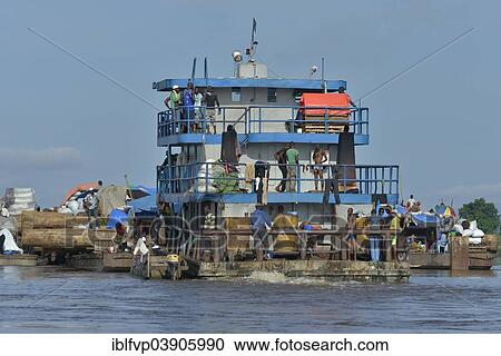 Stock Image - "Freighter transporting logs of tropical timber on the Congo River, near Kinshasa, Kinshasa District, Democratic Republic of the Congo". Fotosearch