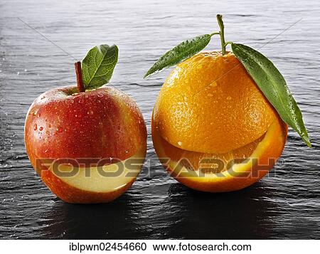 Stock Image - Fresh apple and orange with a smiling mouth. Fotosearch