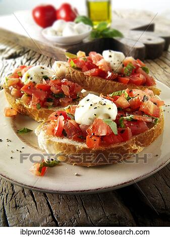 Fresh chopped beefsteak tomato with mini mozerellas bruschettas View Large Photo Image Stock Photo - Fresh chopped beefsteak tomato with mini mozerellas bruschettas. Fotosearch