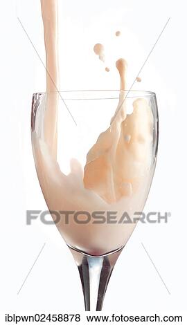 Stock Photo - Fresh flavoured milk being poured into a glass. Fotosearch