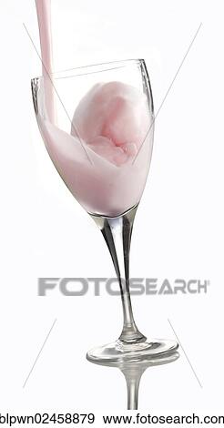 Stock Photo - Fresh flavoured milk being poured into a glass. Fotosearch