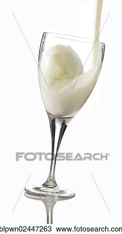 Stock Image - Fresh milk being poured into a glass. Fotosearch