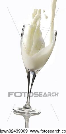 Stock Photo - Fresh milk being poured into a glass. Fotosearch