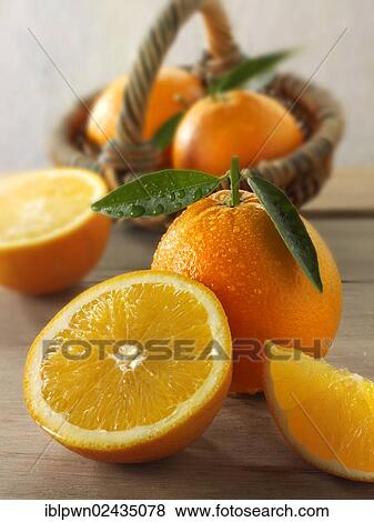 Fresh oranges whole and cut halves with leaves View Large Photo Image Stock Photo - Fresh oranges whole and cut halves with leaves. Fotosearch