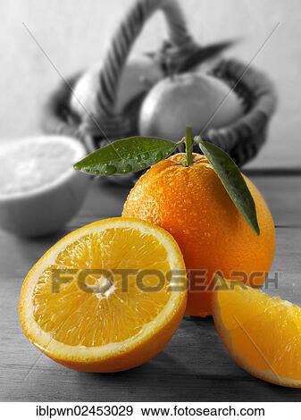 "Fresh oranges, whole and cut, with leaves" View Large Photo Image Stock Photo - "Fresh oranges, whole and cut, with leaves". Fotosearch