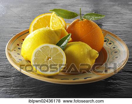 Stock Photo - Fresh whole and cut oranges and lemons. Fotosearch