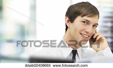 "Friendly businessman speaking on his mobile phone, portrait, smiling" View Large Photo Image Stock Photography - "Friendly businessman speaking on his mobile phone, portrait, smiling". Fotosearch