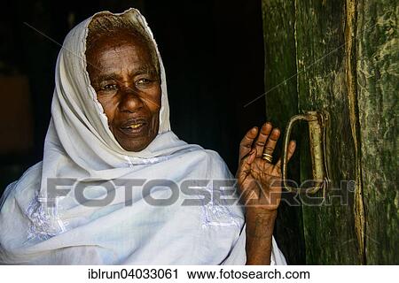 "Friendly old woman standing in a door frame near Keren, Eritrea, Africa" View Large Photo Image Stock Image - "Friendly old woman standing in a door frame near Keren, Eritrea, Africa". Fotosearch