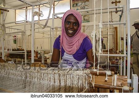 "Friendly woman working on a hand weaving loom in a social project, Eritrea, Africa" View Large Photo Image Stock Photography - "Friendly woman working on a hand weaving loom in a social project, Eritrea, Africa". Fotosearch