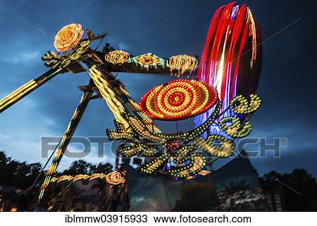 Stock Image - "Frisbee fair ride at night, Munich Spring Festival, Theresienwiese, Munich, Bavaria, Germany, Europe". Fotosearch