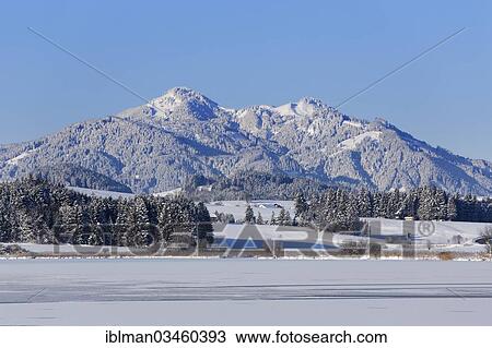 "Frozen Hopfensee Lake with Mount Edelsberg and Mount Alpspitz, near Hopfen am See, Ostallgau, Allgau, Schwabia, Bavaria, Germany, Europe" View Large Photo Image Stock Image - "Frozen Hopfensee Lake with Mount Edelsberg and Mount Alpspitz, near Hopfen am See, Ostallgau, Allgau, Schwabia, Bavaria, Germany, Europe". Fotosearch